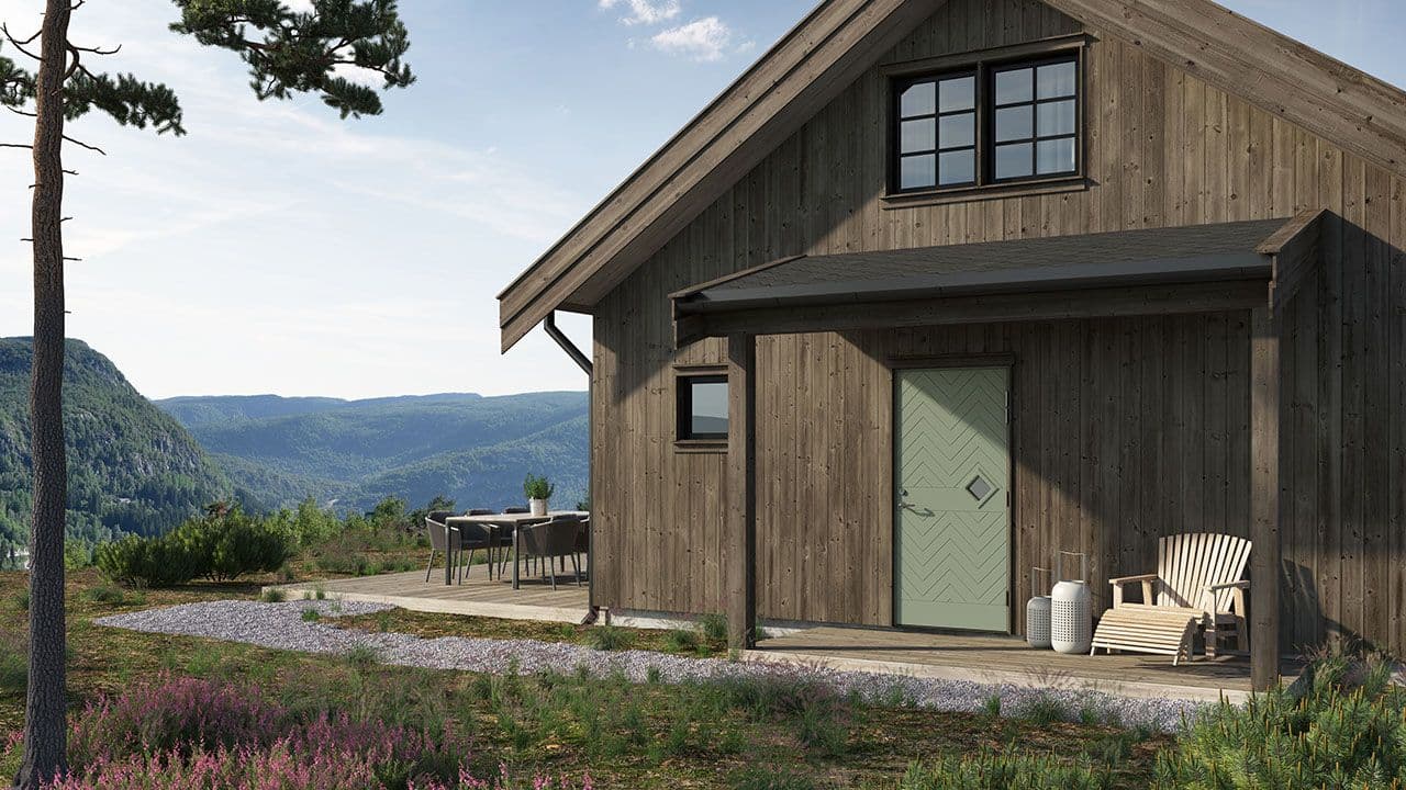 Hytte på fjellet med grønn hyttedør.